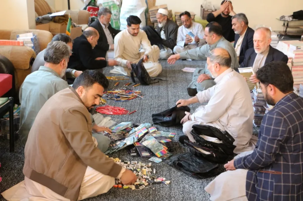 Volunteers of Imam Jawad Charity Organization preparing school supply packages for vulnerable students in Afghanistan.